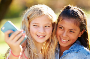 Two Girls Taking Selfie With Mobile Phone